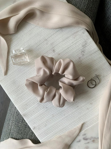Baby scrunchie on a beige fabric.