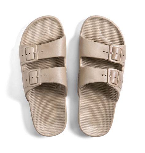 Women's two strap beige sandals with fixed buckles.