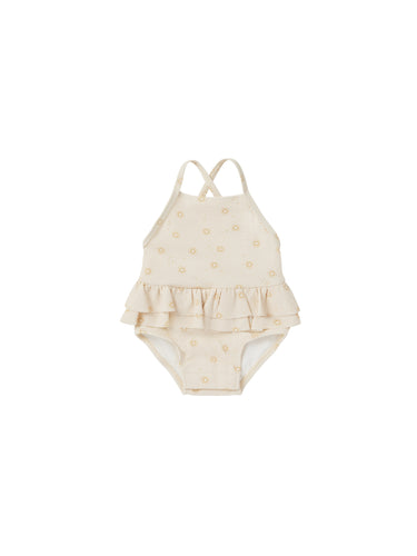 Ivory one-piece bathing suit with a ruffle waist and all over sun print. 